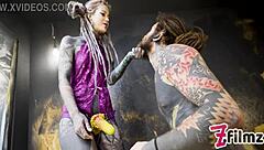 alt dominatrix with tattooed worker in intense session
