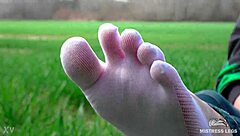 goddess feet in cute white socks on spring grass field 🌸