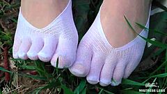 goddess feet in cute white socks on spring grass field 🌸