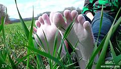 goddess feet in cute white socks on spring grass field 🌸