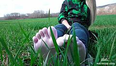 goddess feet in cute white socks on spring grass field 🌸