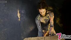 alt dominatrix with tattooed worker in intense session