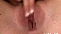 high heeled hottie riley shy fingers herself on the bed, shoving a long glass dildo deep into her pussy until orgasm.