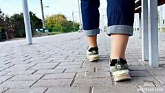 i tease my tan nylon soles in blue jeans on the bench outdoors