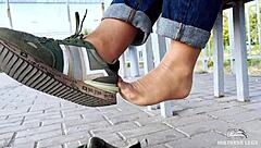 i tease my tan nylon soles in blue jeans on the bench outdoors