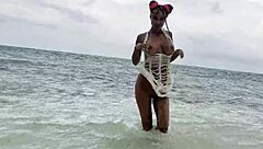 Fox appeals, naked, on the white sand beach