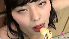 kitchen babe licks candy with naughty look