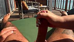 Stunning brunette gives amazing handjob on the terrace