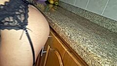 Maid heats up while cleaning the kitchen.