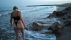 Blonde boldly flashes tits and sucks cock on public beach