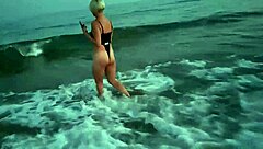 Blonde boldly flashes tits and sucks cock on public beach