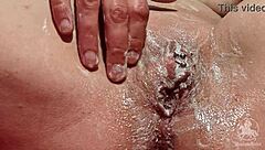 Woman in Bathroom Trims Her Wet Pussy Lips and Clit with Tattoo Visible