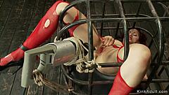 brunette in cage gets drilled by machine