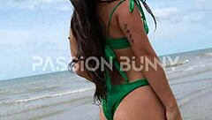 A girl is walking on the beach in a sexy way