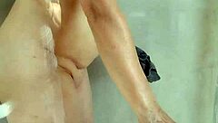 A hot girl is cleaning with no clothes on, showcasing her allure
