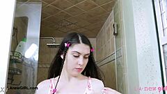 Brunette model with long hair takes shower during photoshoot