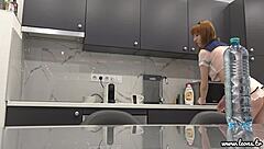 Tall Latvian redhead Lilly shows off in transparent skirt and top in the kitchen