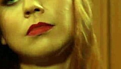 Two hot lesbian slaves kiss while madame touches them