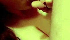 A redhead milf is sucking on a hard cock in a casual setting.