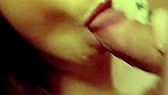 A redhead milf is sucking on a hard cock in a casual setting.