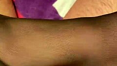 Giving the hubby a footjob in black reinforced toe stockings