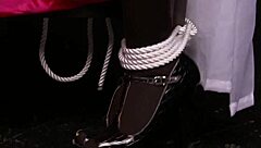 two big-tits lesbians rub together in bondage lingerie.