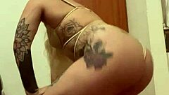 Blonde with tattoos in an erotic display