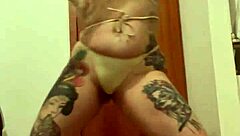 Blonde with tattoos in an erotic display