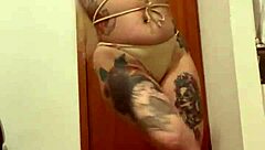 Blonde with tattoos in an erotic display