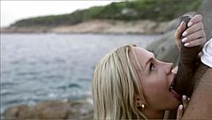 blonde rides lifeguard cock behind beach rocks