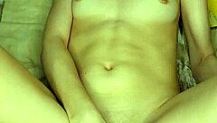 A girl in beautiful white lingerie caresses herself and fucks herself with a big pink dildo