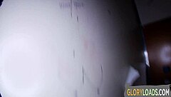 Babe titty fucks cock at gloryhole and takes cumshot