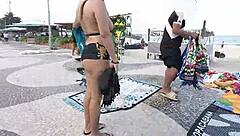Sexy milf blonde flashes in mini short on Copacabana beach with guys staring