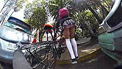 Exhibiting miniskirt upskirt through city streets with pigtails and socks