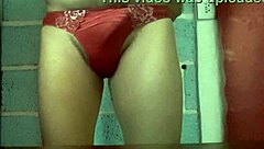 she models her wife's panties in a teasing display before slipping them off for a close-up view