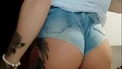 Watch this naughty babe flaunt her huge clit and hairy pussy in tight jeans shorts - no panties!