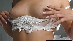 Petite Canadian beauty Alexandra Belle slips out of pajamas for a teasing striptease pose.