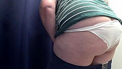 I spy on a chubby milf with big ass in white panties trying tight leggings in the fitting room, camera capturing every close-up detail of her curvy blonde body