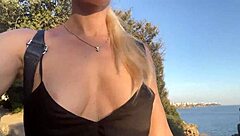 girl flashes tits outdoors without underwear among strangers near the sea