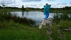 mature lady in bikini dancing on the lake