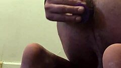 She warms up her ass with a small dildo.