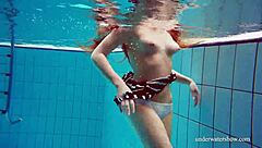 Cute hairy teen Nina swims naked in pool.