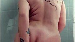 Tattooed Brunette Enjoys Playing in the Bathtub with Toys