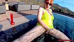 Red XXX teases pussy with toy by pool