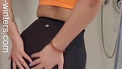 Hey, check out this hot babe in sports bra and leggings getting off in the shower! 😏