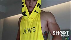 Asian gay hunk participates in a shooting session with other men. He poses confidently.