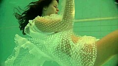 Russian babe Natalia swims nude and strips