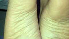 A man cums all over a woman's feet during a footjob