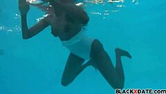 Sensual ebony babe in a see-through swimsuit underwater