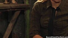 rough strapon penetration punishes the bound lesbian slave under the mistress's domination.